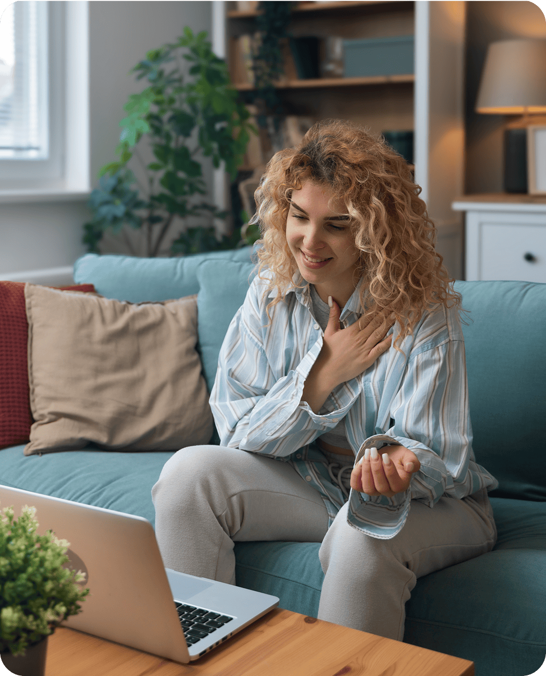 Woman video calling on laptop at home